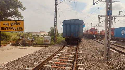 New Phulera station board on the Western Dedicated Freight Corridor, with freight locomotives and a container train