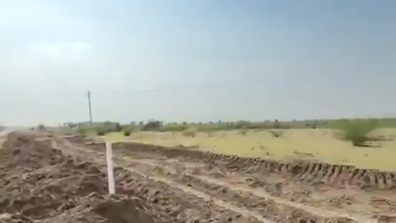 A marker post on a ploughed field